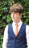 A person wearing a blue shirt and orange tie  Description automatically generated with low confidence